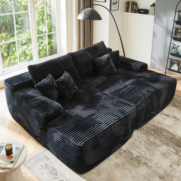 The Ovios black ribbed corduroy sectional sofa anchors the bright modern living room with deep seats and matching pillows