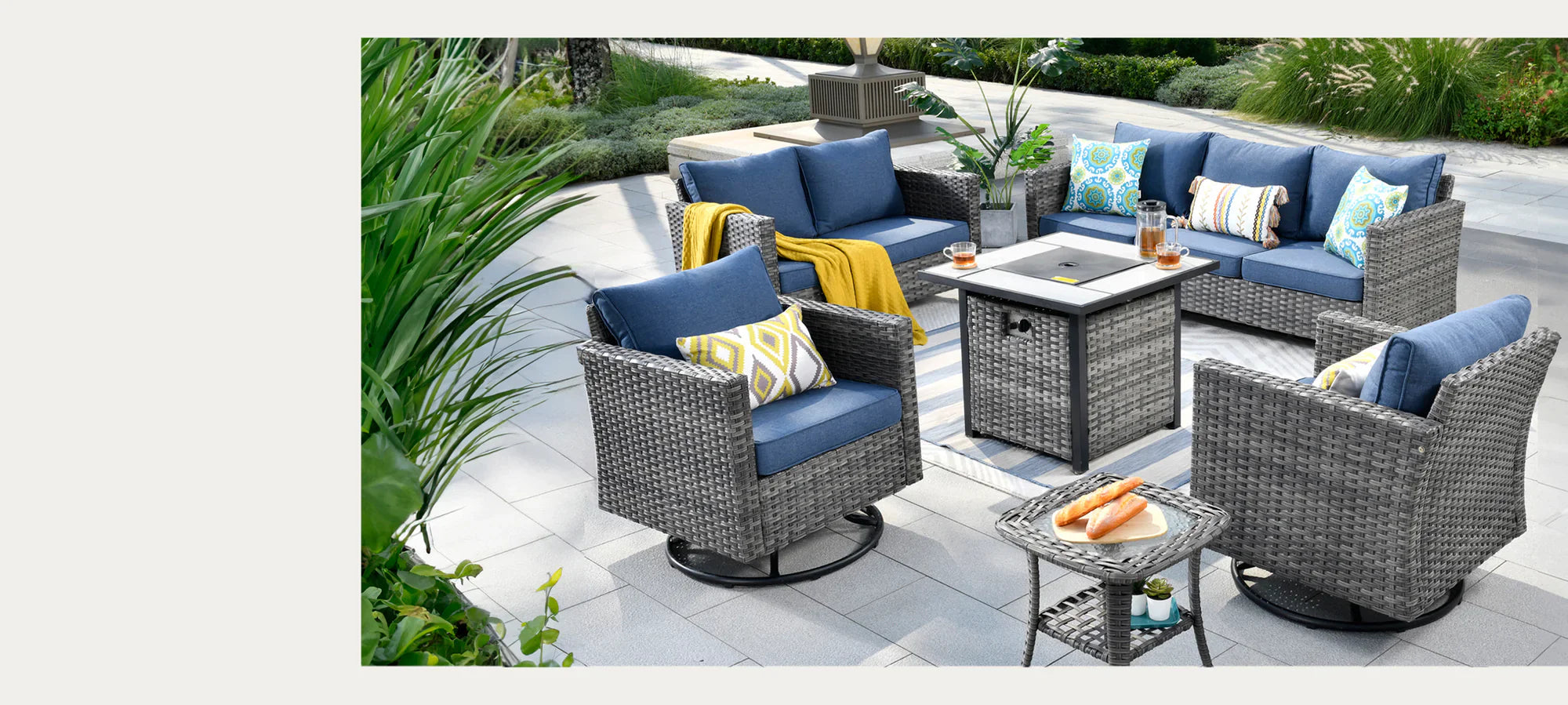 A six-piece outdoor patio furniture set with gray wicker and blue cushions