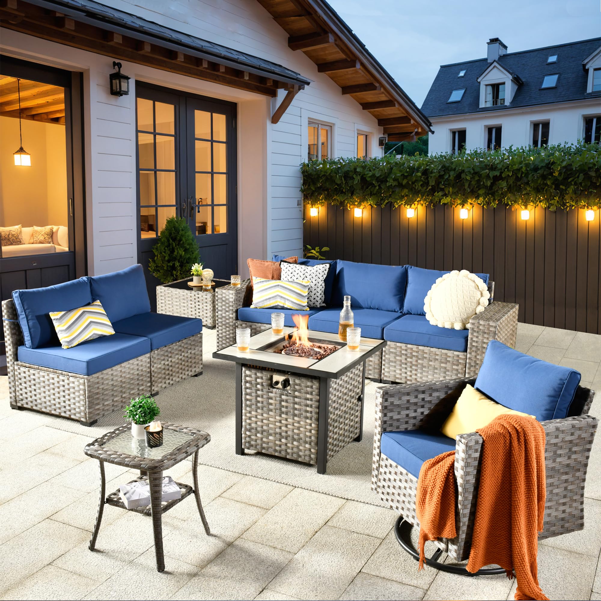 Navy Blue Ovios 9-piece modular rattan patio set with fire pit table & swivel chair.