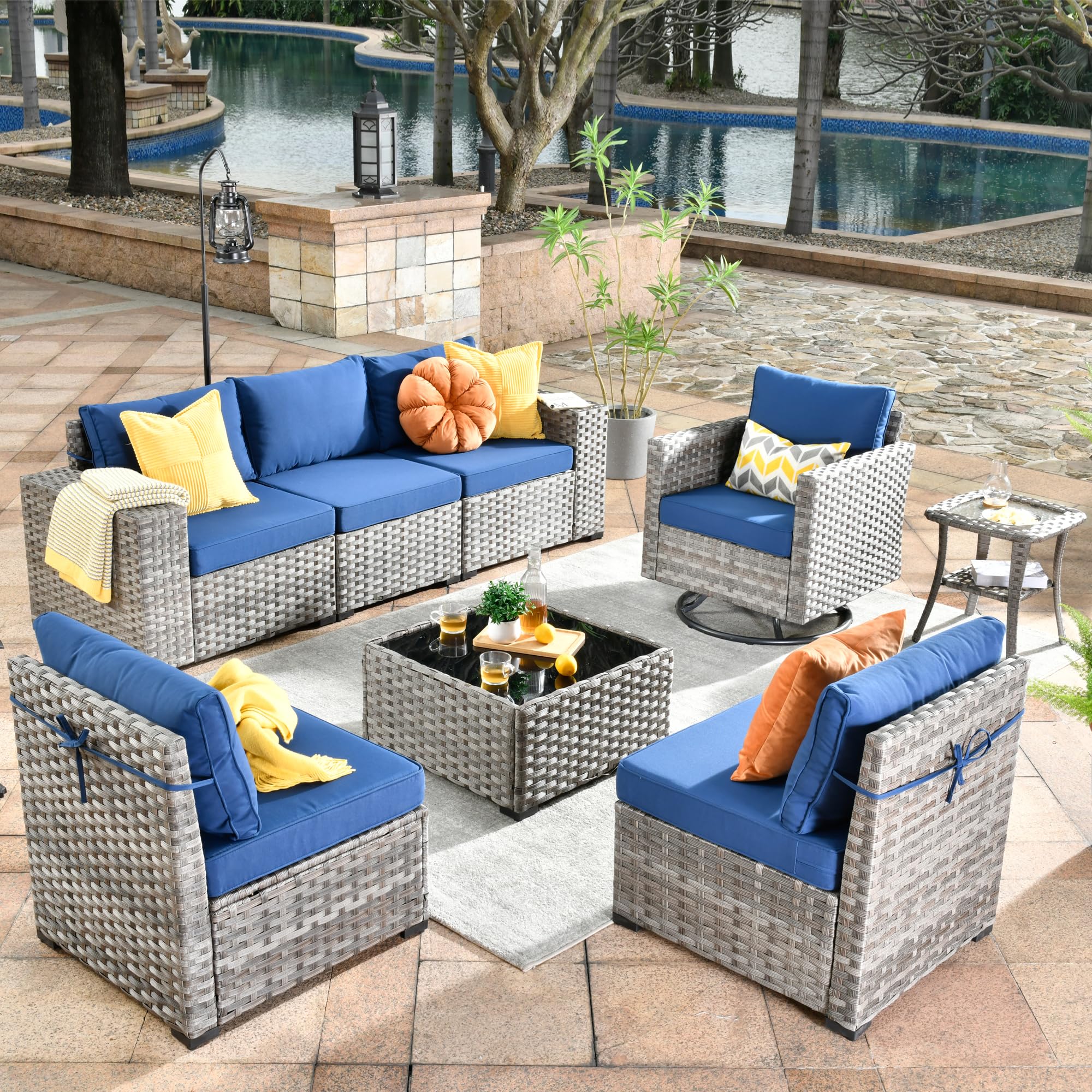 Ovios 8-piece grey wicker patio furniture set with Navy Blue cushions, swivel chair & coffee table.