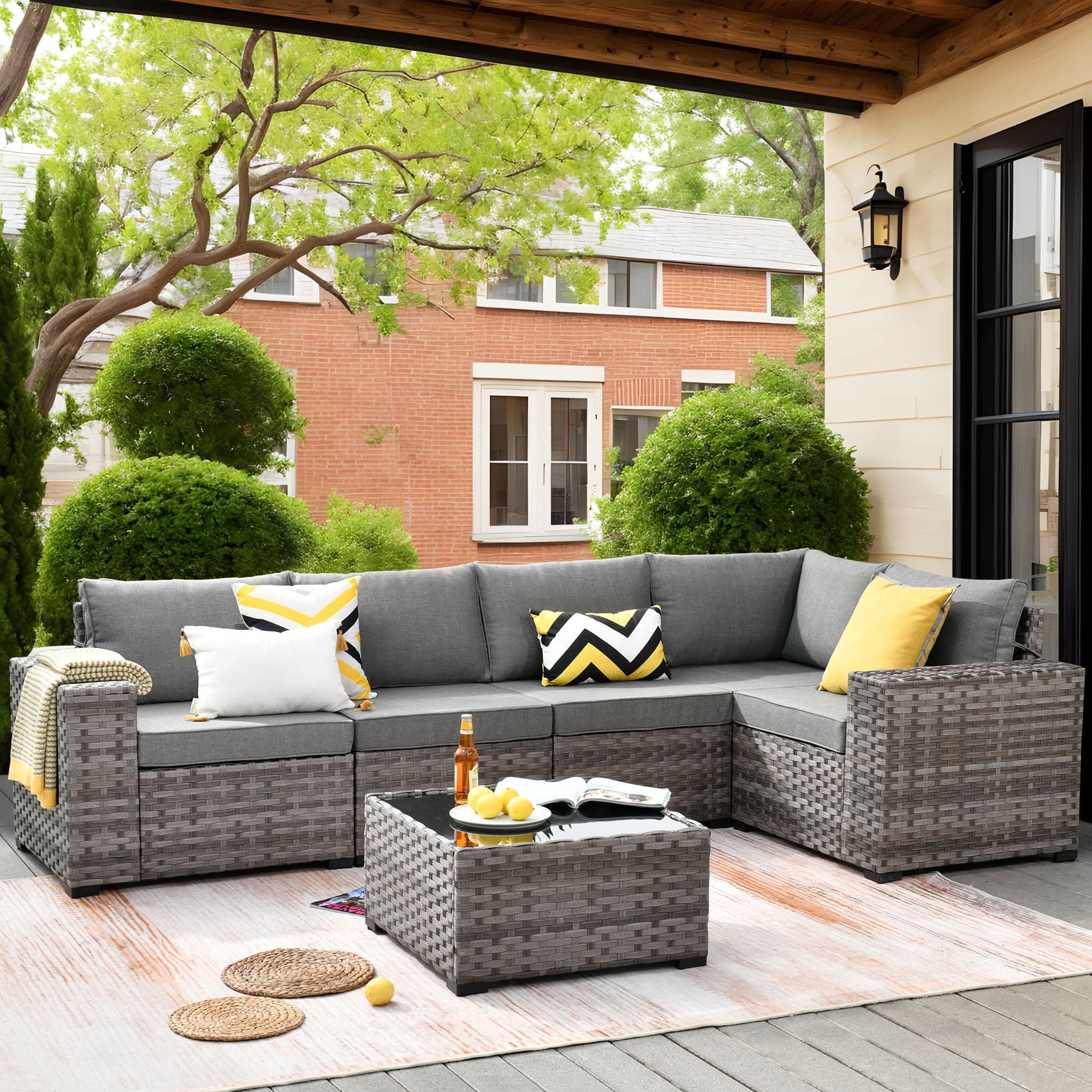 Dark Grey | OVIOS outdoor sectional sofa set with gray wicker frame, gray cushions, and decorative pillows on a patio