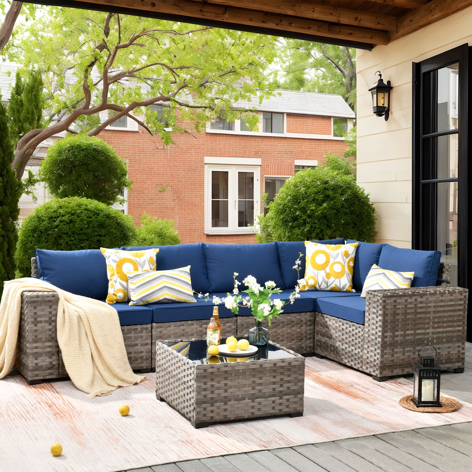 Navy Blue OVIOS outdoor sectional sofa set with blue cushions and gray wicker frame on patio