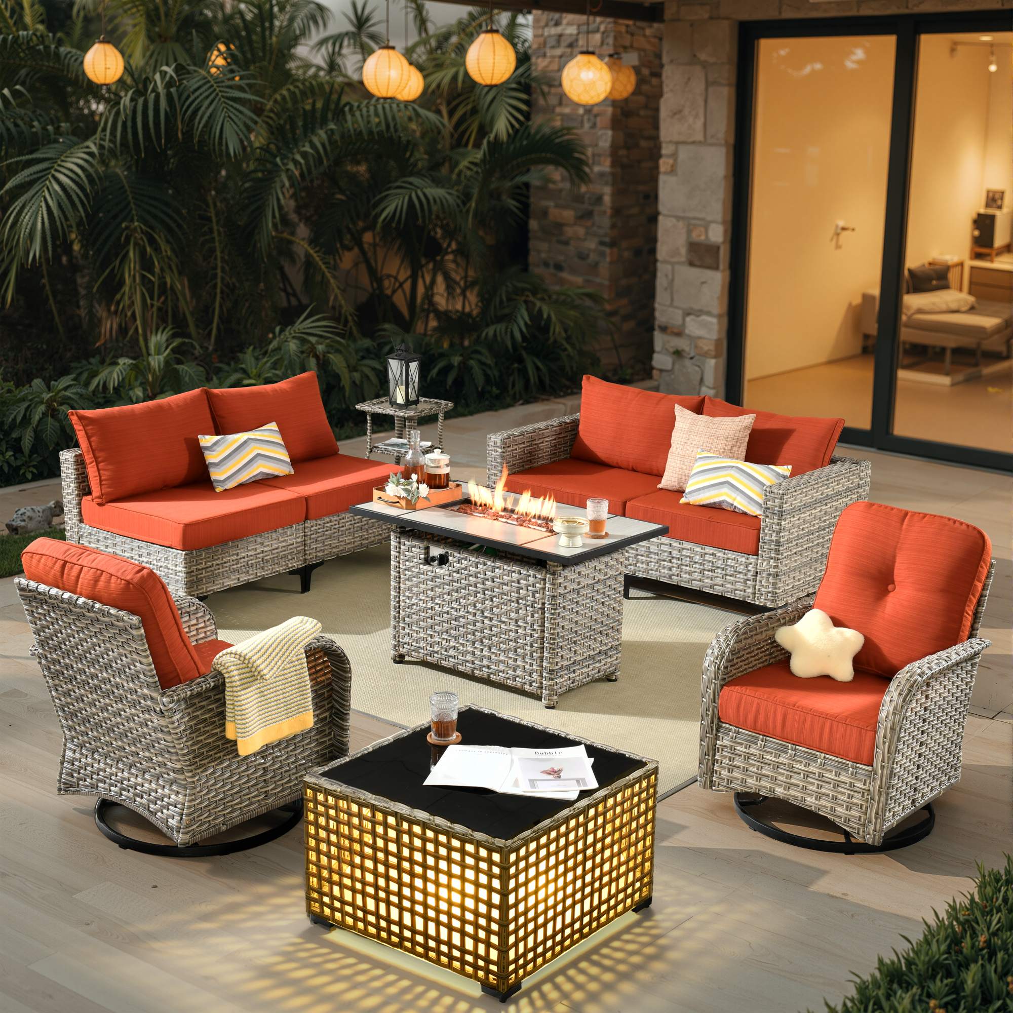 OVIOS All-Weather patio set with orange cushion swivel chairs and fire table.