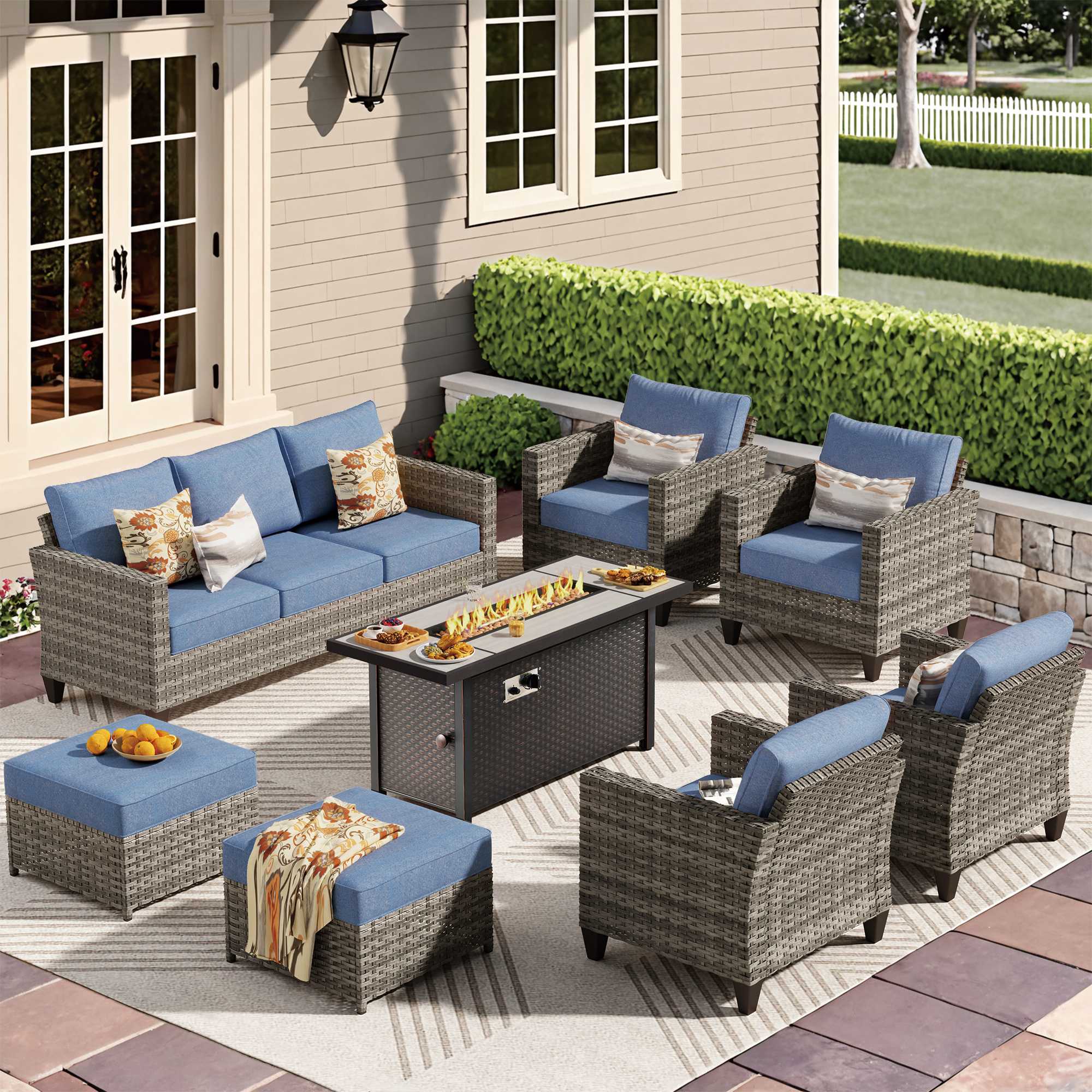 Denim Blue | Gray wicker outdoor patio conversation set with blue cushions and fire pit table.