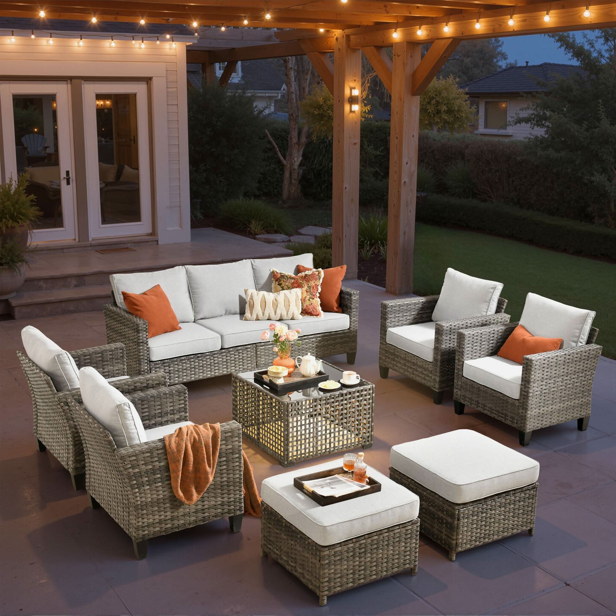 Grey | OVIOS 8-piece wicker patio set with sofa, chairs, ottomans, and solar table.