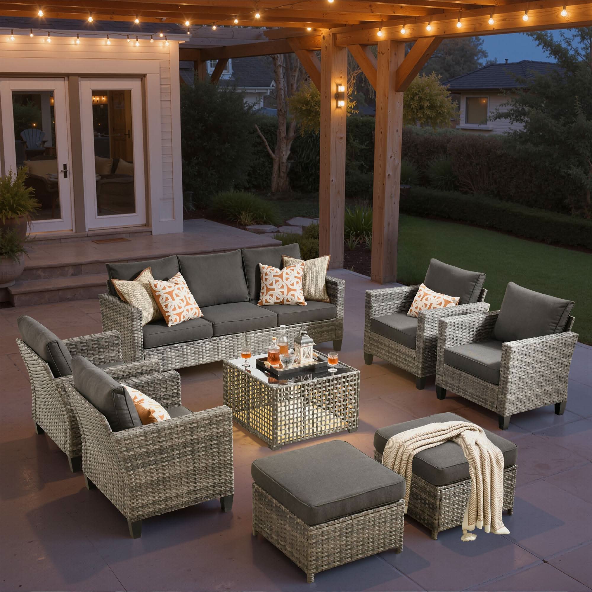 Black | OVIOS 8-piece grey wicker patio conversation set with dark cushions and solar table.