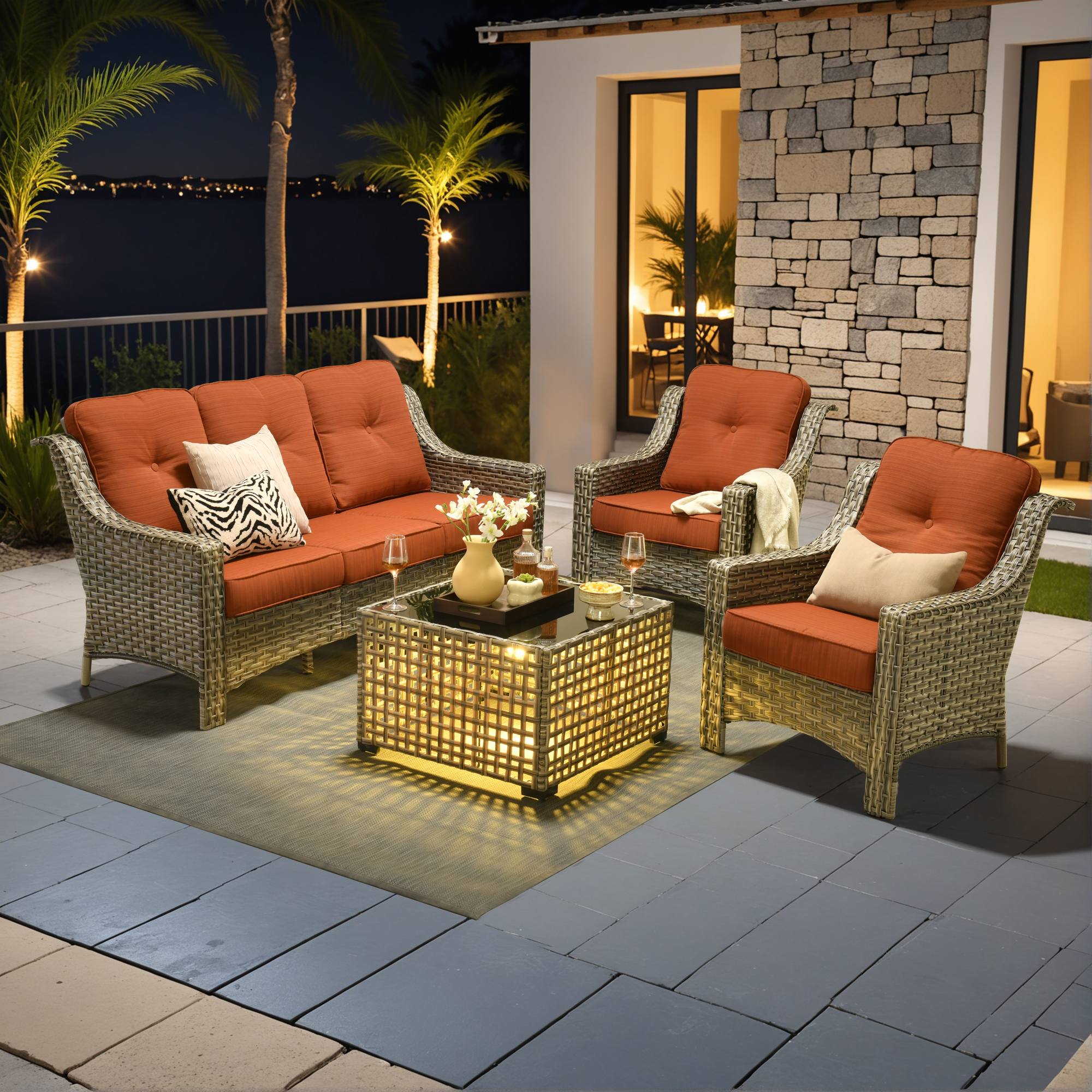Ovios PAD Series 5-piece wicker outdoor furniture set with orange cushions, sofa, swivel chairs.