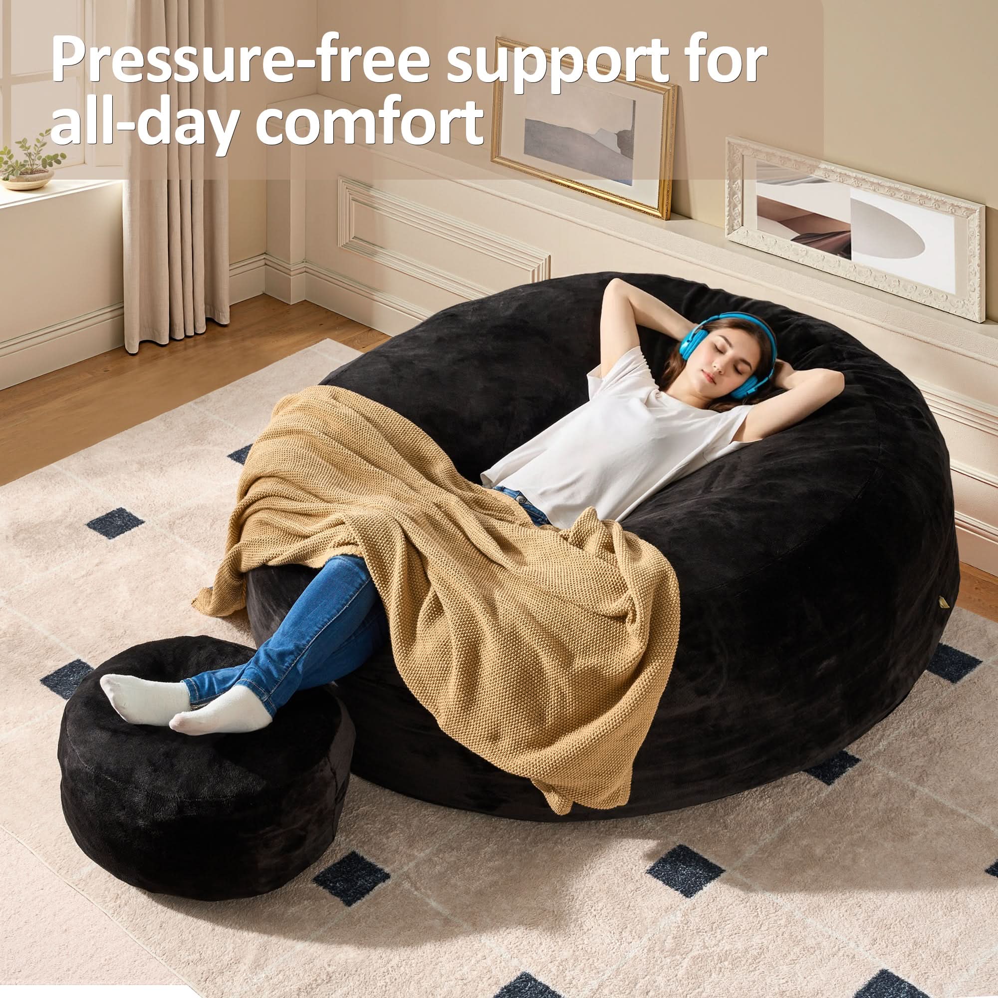 Ovios black bean bag chair and ottoman set. Woman relaxing on cozy, high-rebound memory foam furniture.
