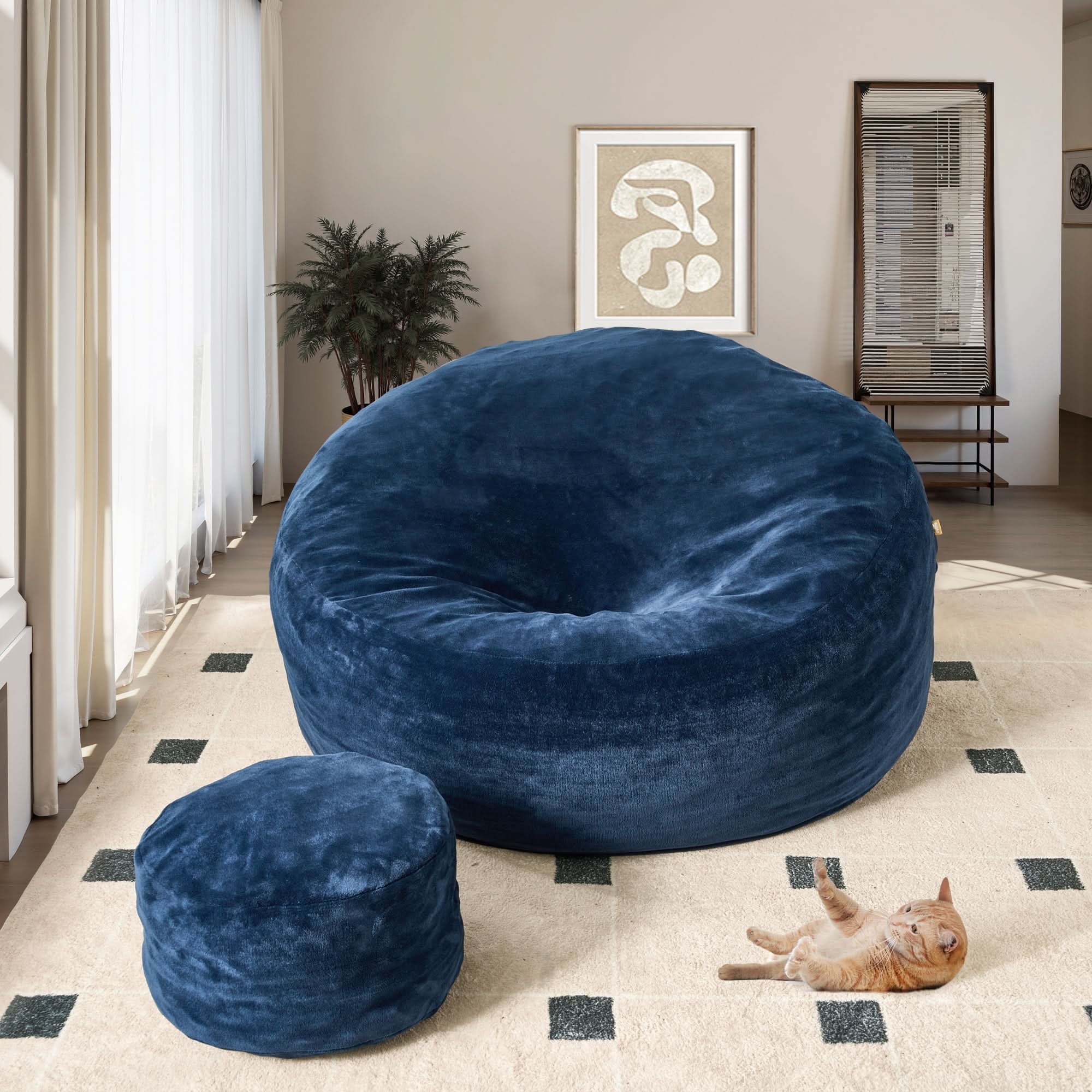 Navy blue Ovios bean bag chair and ottoman set with cat on a cozy rug. High-rebound foam living room furniture.