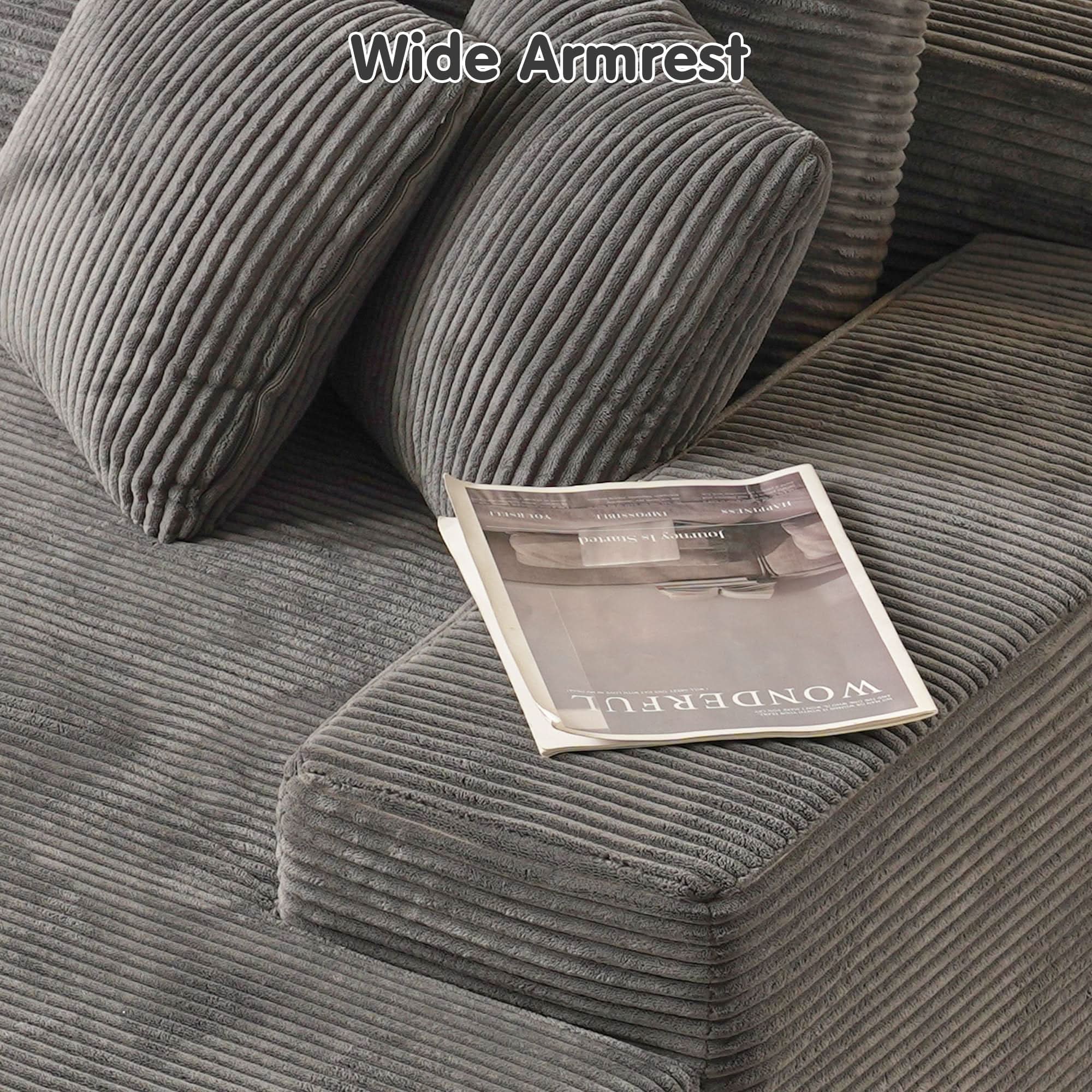 Gray corduroy sectional sofa with wide armrest, featuring a magazine, demonstrating comfort and style