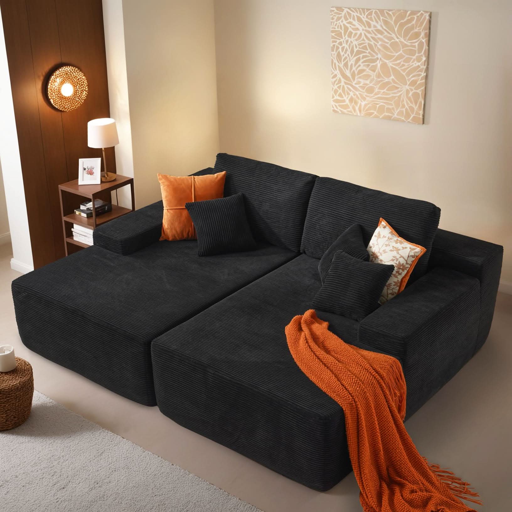 Ovios sectional sofa in dark gray corduroy with double chaise, accent pillows, and an orange throw. Perfect for comfort.