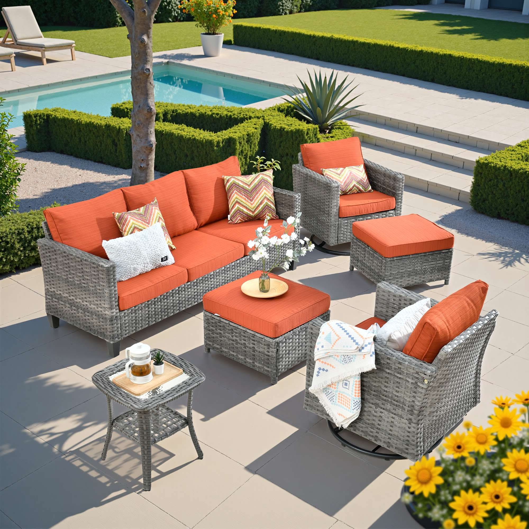 OVIOS outdoor wicker patio set: sofa, swivel rocking chairs, ottomans with orange cushions.