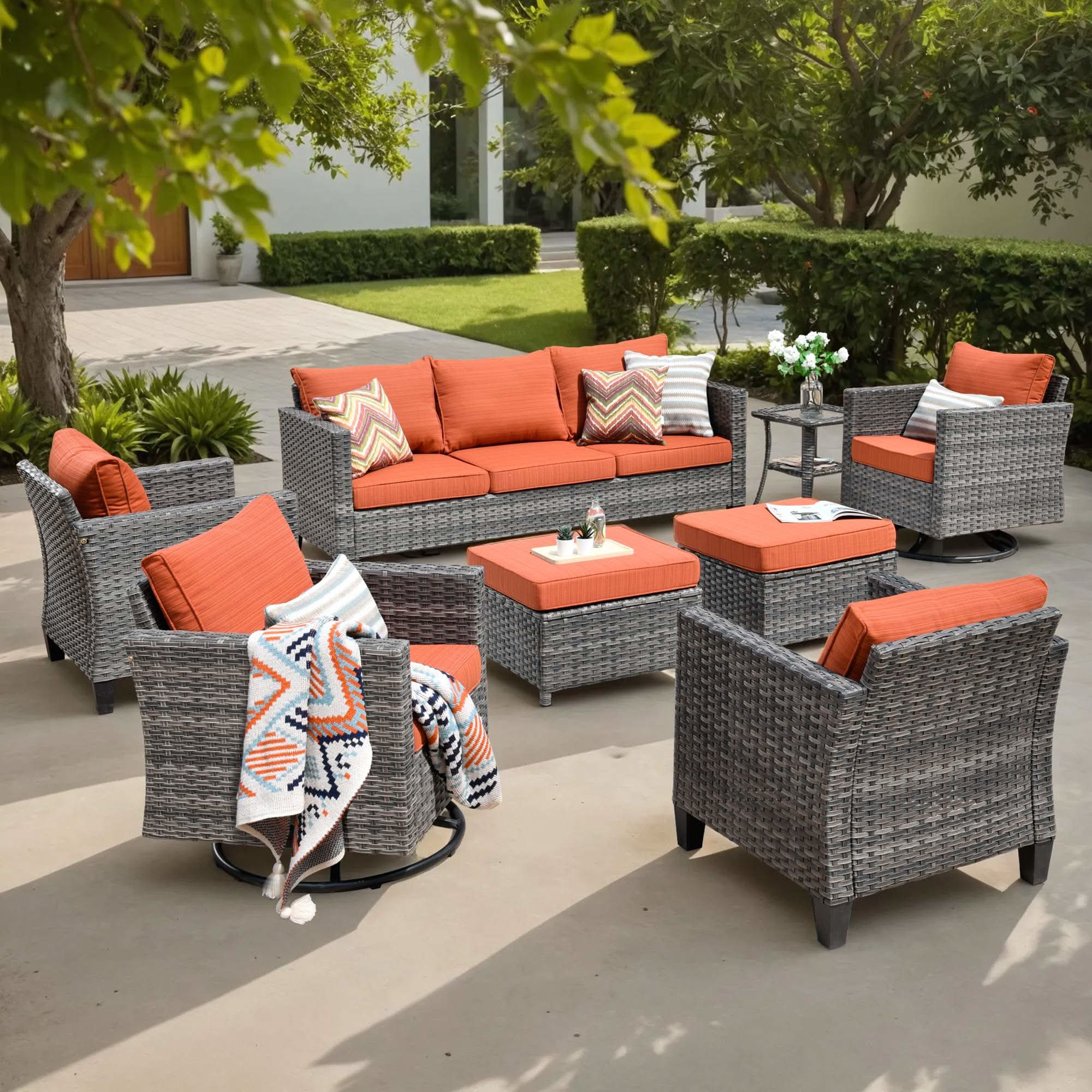 OVIOS 8-piece grey wicker patio conversation set with sofa, chairs, and orange cushions.
