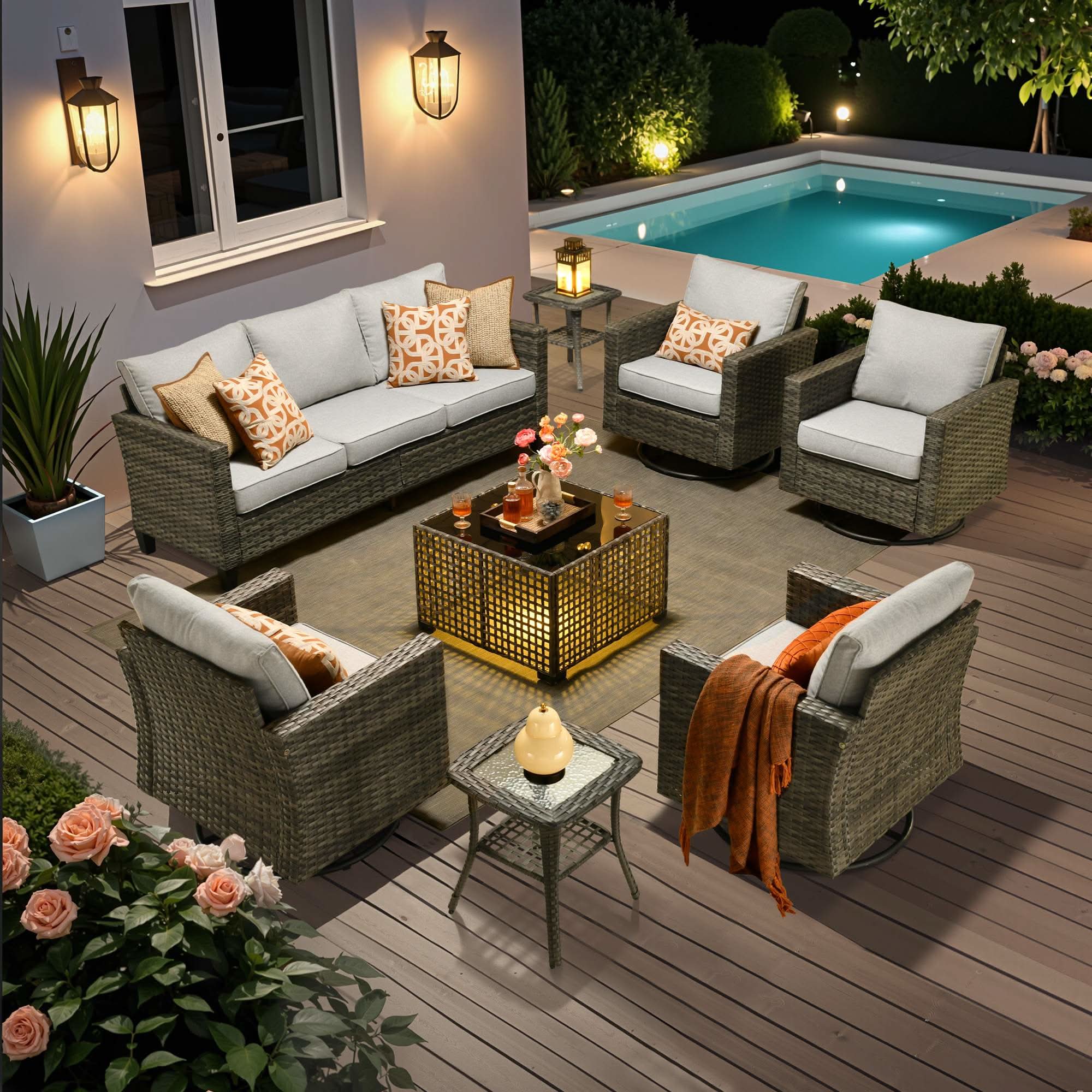 Grey | OVIOS 8-piece wicker patio conversation set with swivel chairs and solar table by the pool.