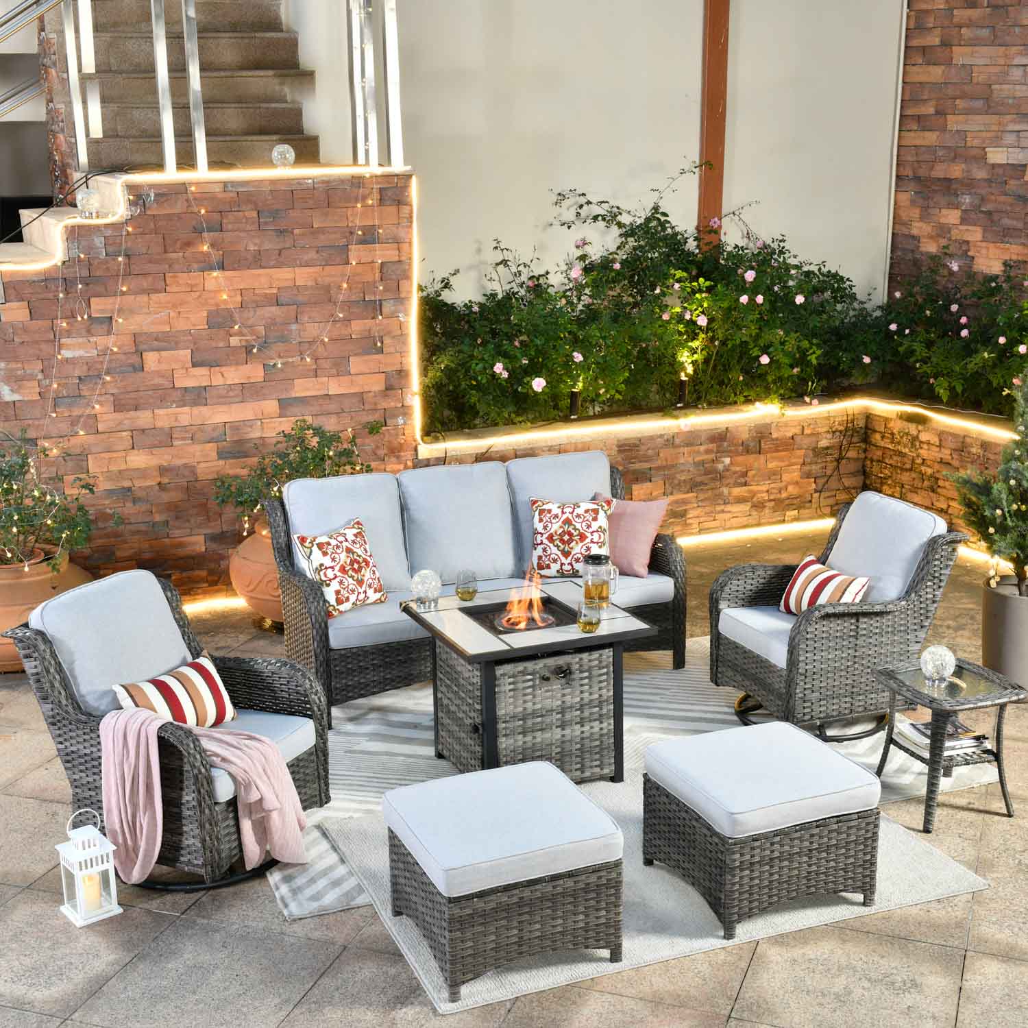 Enjoy cozy evenings with this Ovios patio furniture set, featuring a stylish fire pit table, grey wicker seating, and comfortable cushions