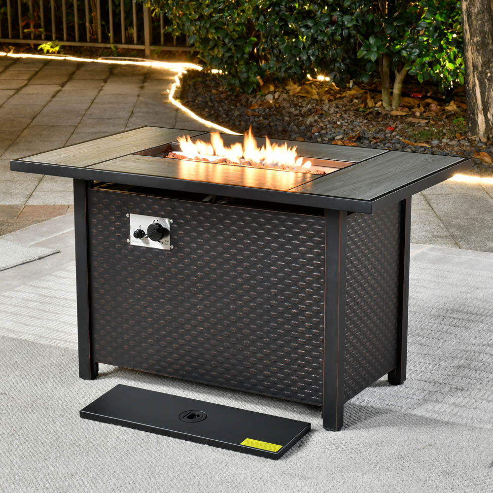 General |Ovios 42'' brown rectangle propane fire pit table with woven base and flames.
