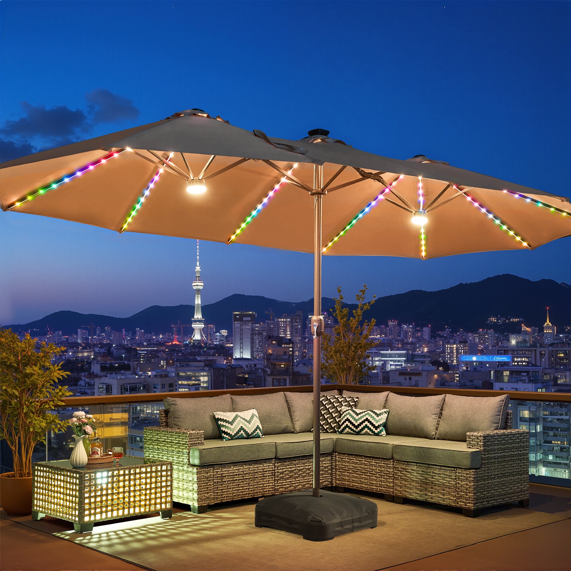 Beige | OVIOS 15ft patio umbrella with colorful RGB LED lights glowing at night over a city skyline.